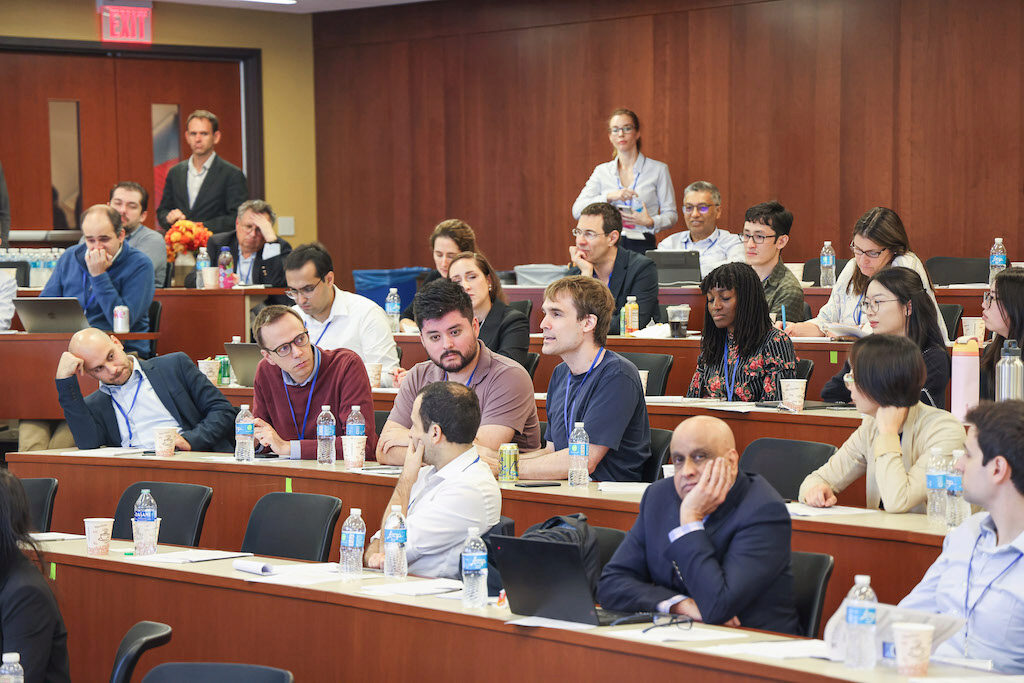 Audience members asking questions in a lecture hall
