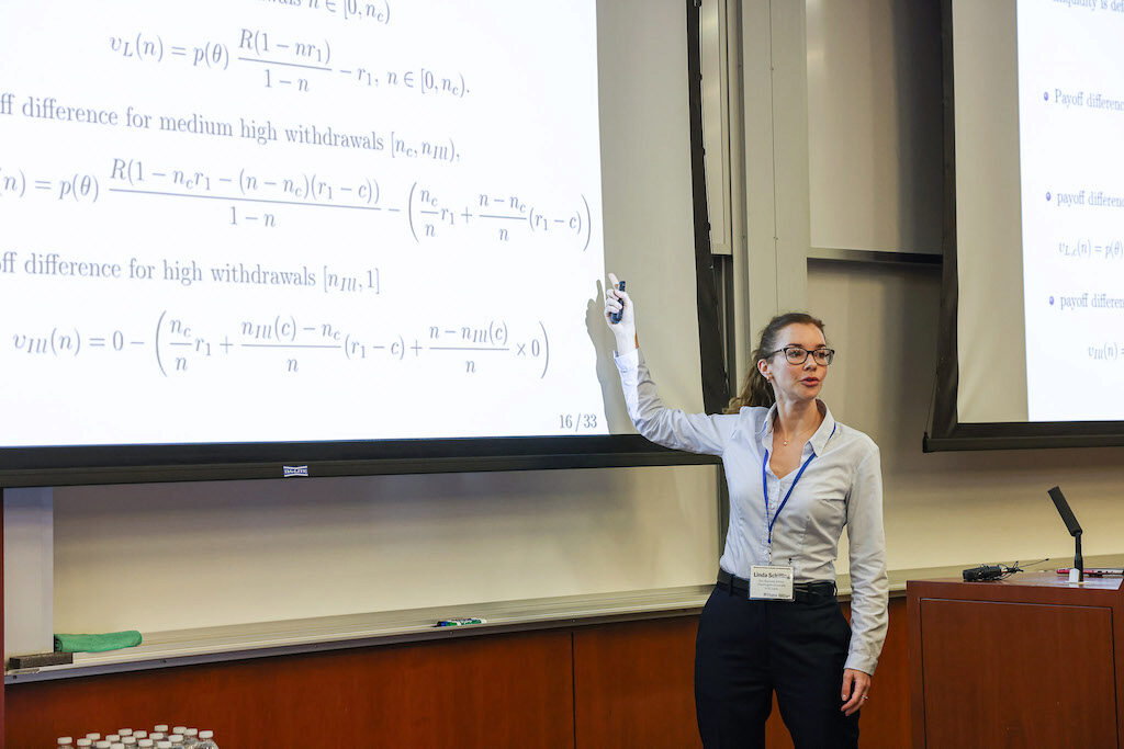 Linda Schilling points up to a screen while lecturing