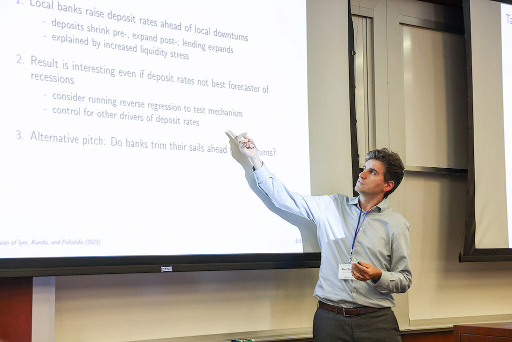 Alexi Savov points up to a screen