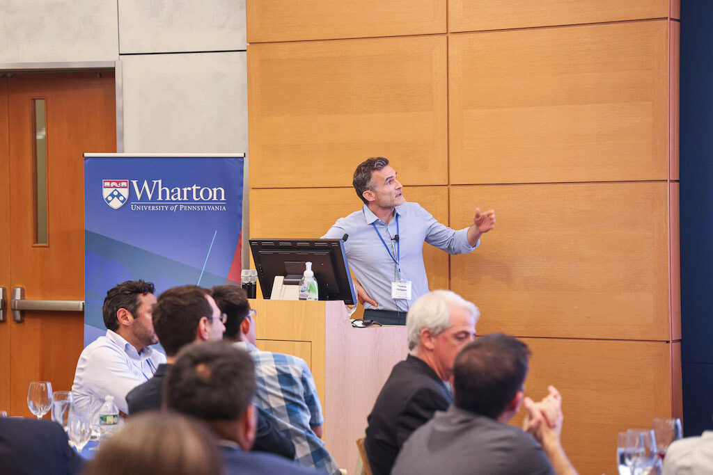 Keynote speaker Thomas Philippon speaks while addressing something behind him.