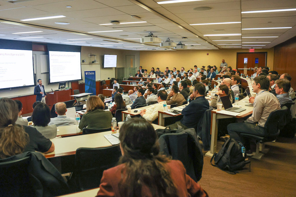 A lecturer addresses a packed audience