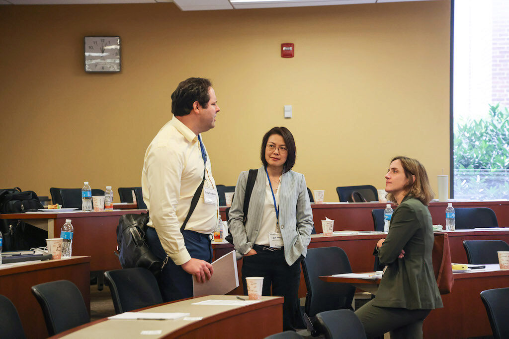 Conference attendees chat between lectures