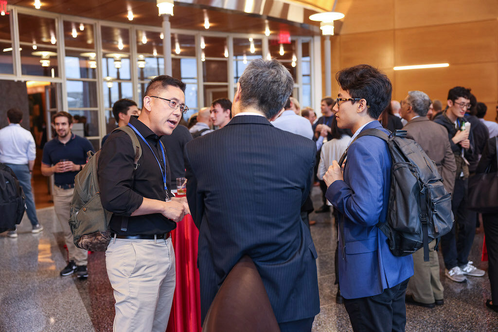 Conference attendees chat during a reception
