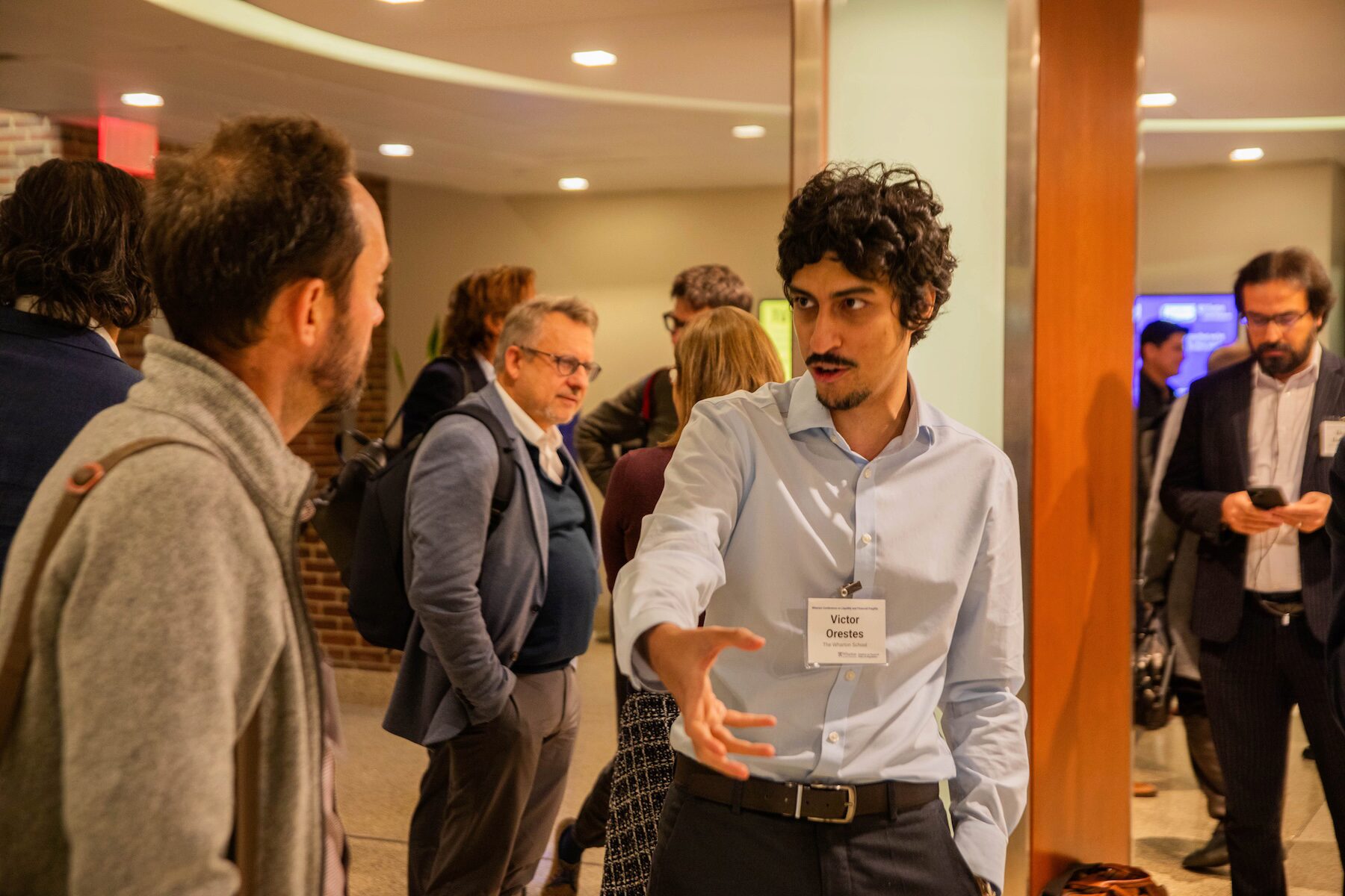 Conference participants mingling at a reception